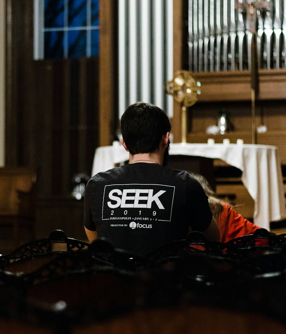 person wearing black and white Seek shirt