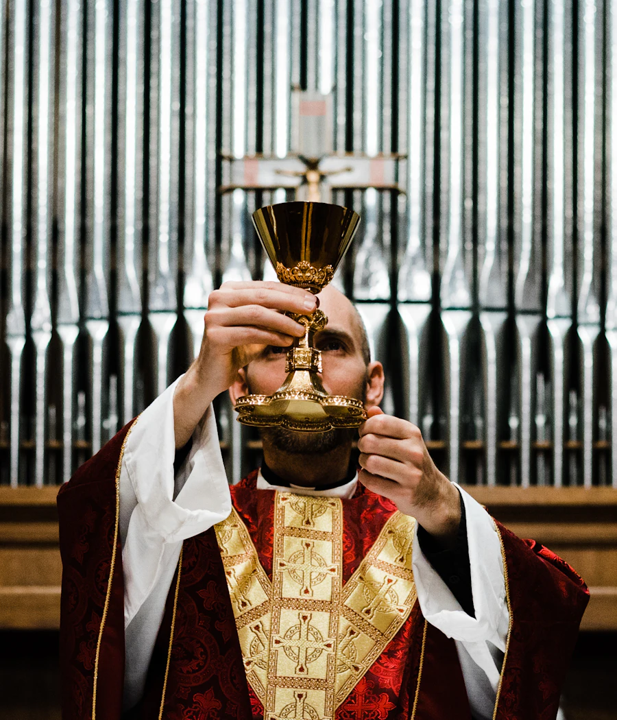 A priest raising the chalice at the consecration during Mass
