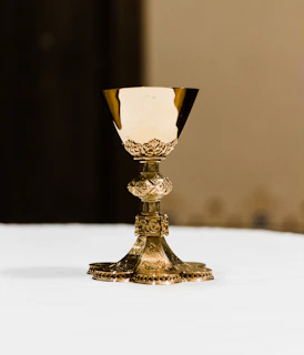 A detailed close-up of an ornate colonial-era silver chalice displayed in the museum.
