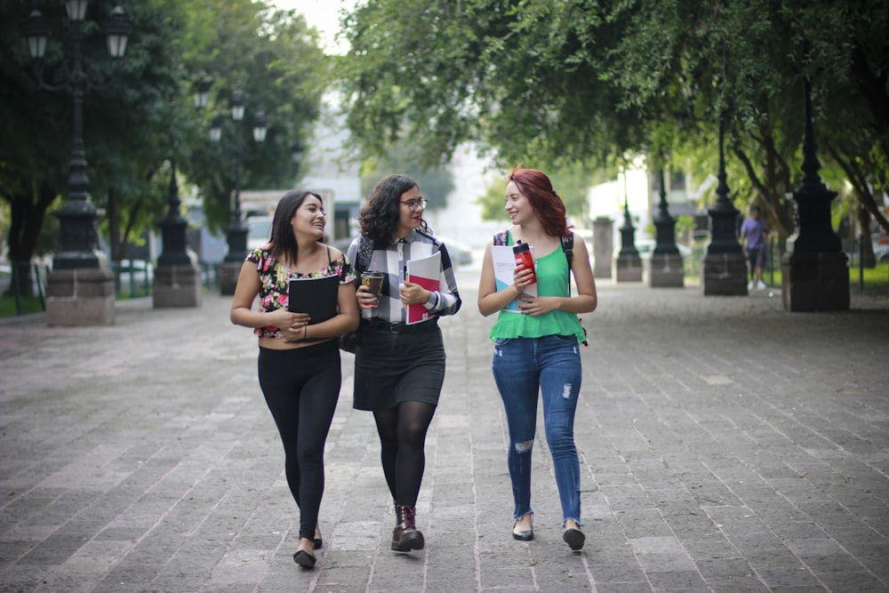 three women walking on park