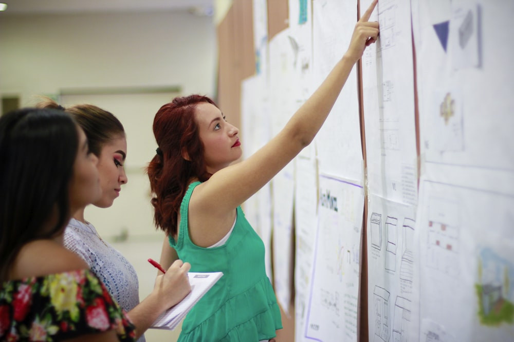 woman pointing at paper