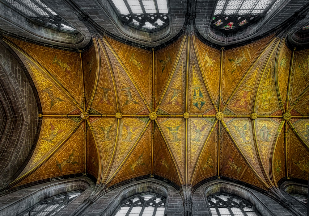 selective color photography of gold and gray church ceiling