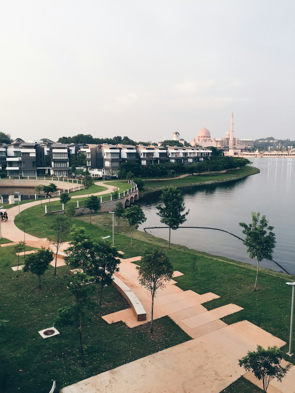 top view of walkway between trees facing body of water