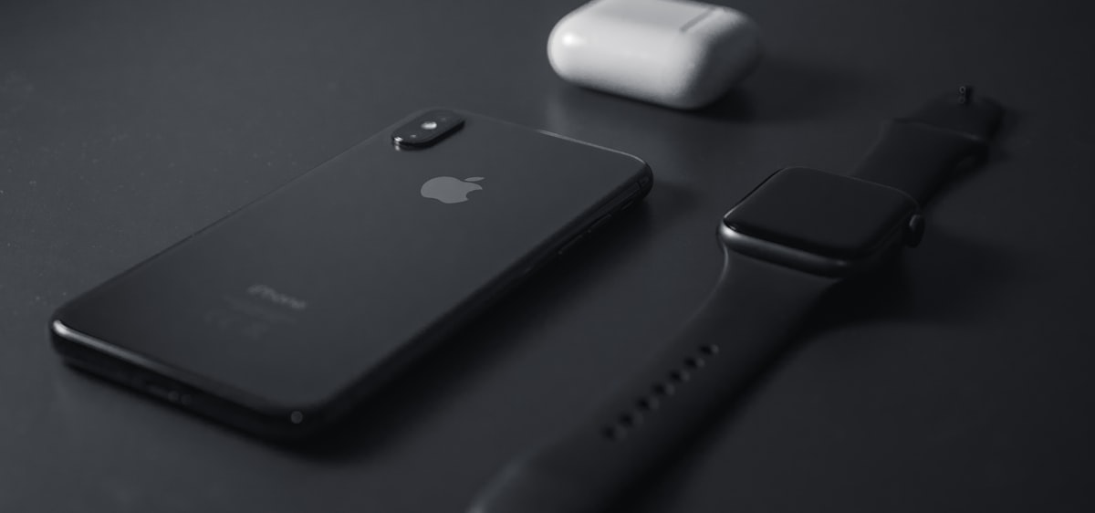 iPhone and Apple Watch on a clean surface ready to capture a screenshot