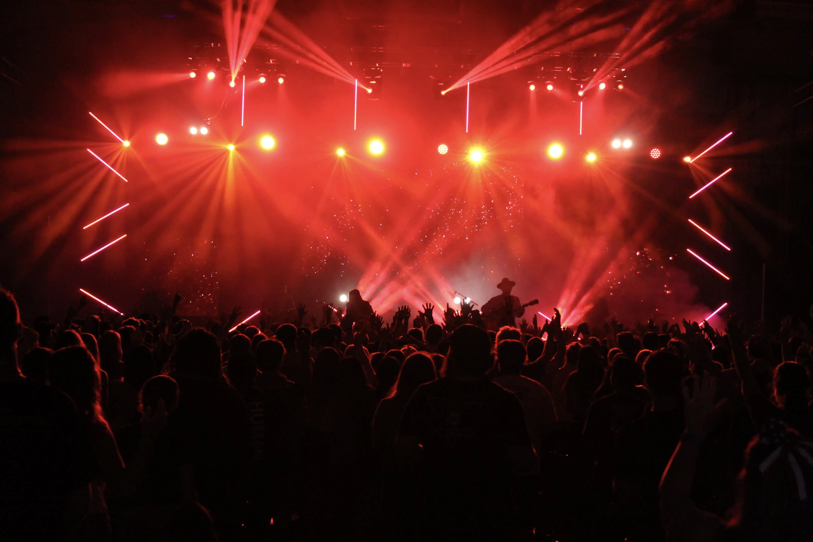 A crowd immersed in red concert lights