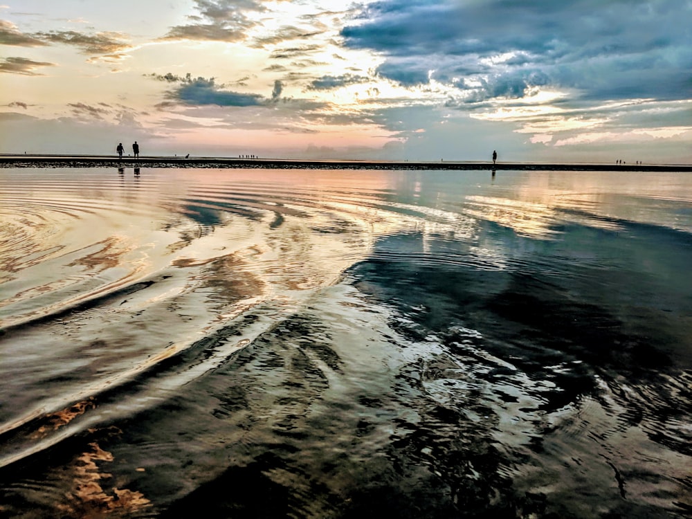 blue sea under cloudy sky