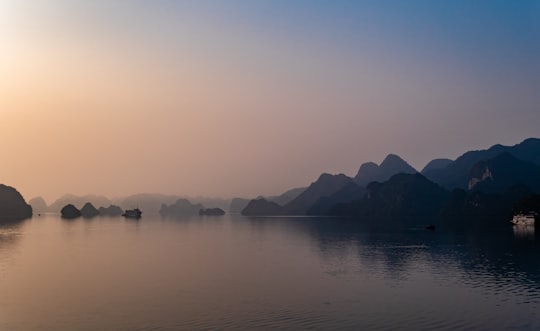 silhouette of mountains near calm body of water in Halong Bay Vietnam