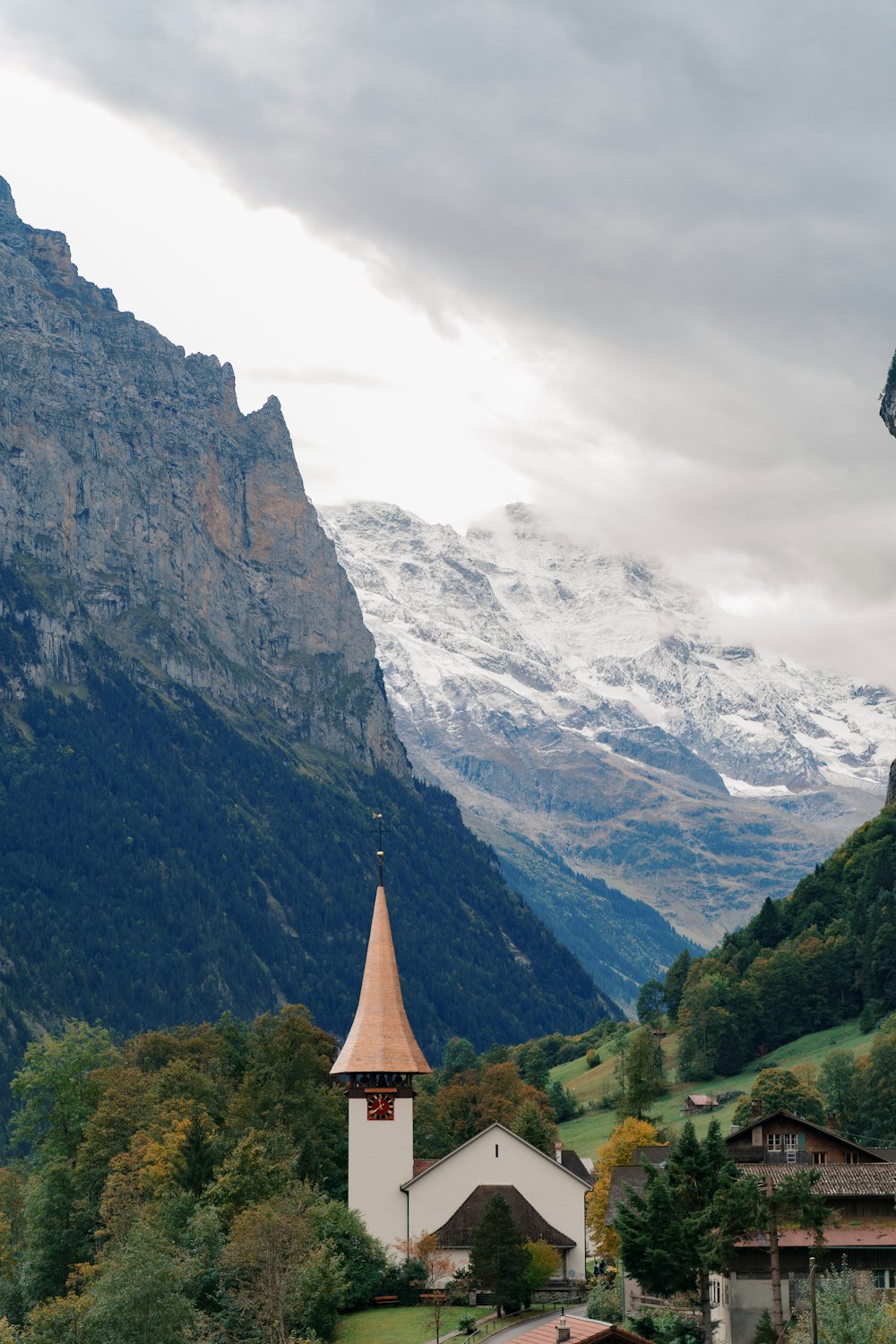 white and brown cement houses with mountains