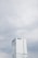 A tall, modern skyscraper with a sleek glass facade and the Prudential Financial logo near the top, set against a backdrop of overcast skies.