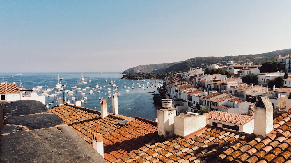 white boat lot on sea beside mountain