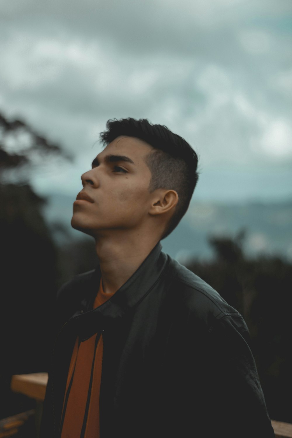 man wearing black leather zip-up jacket