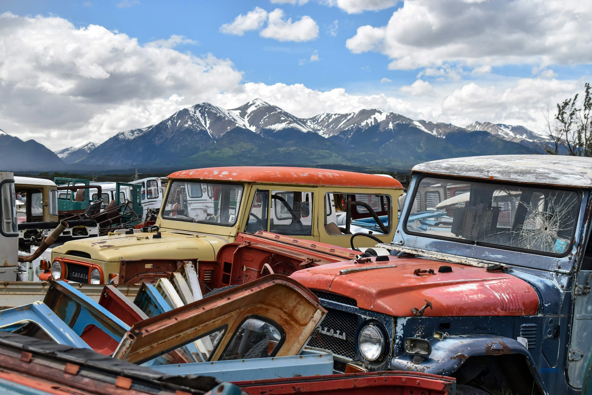 woman wearing yellow long-sleeved dress under white clouds and blue sky during daytime
