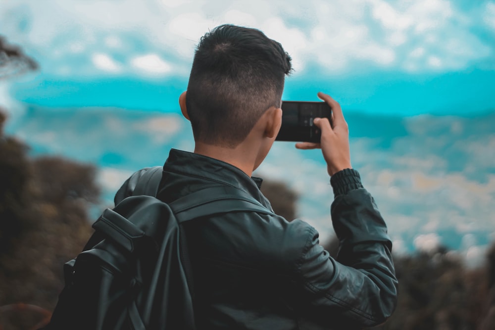 person holding black smartphone