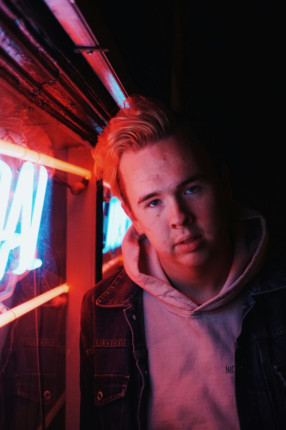 man in white hoodie and black denim jacket