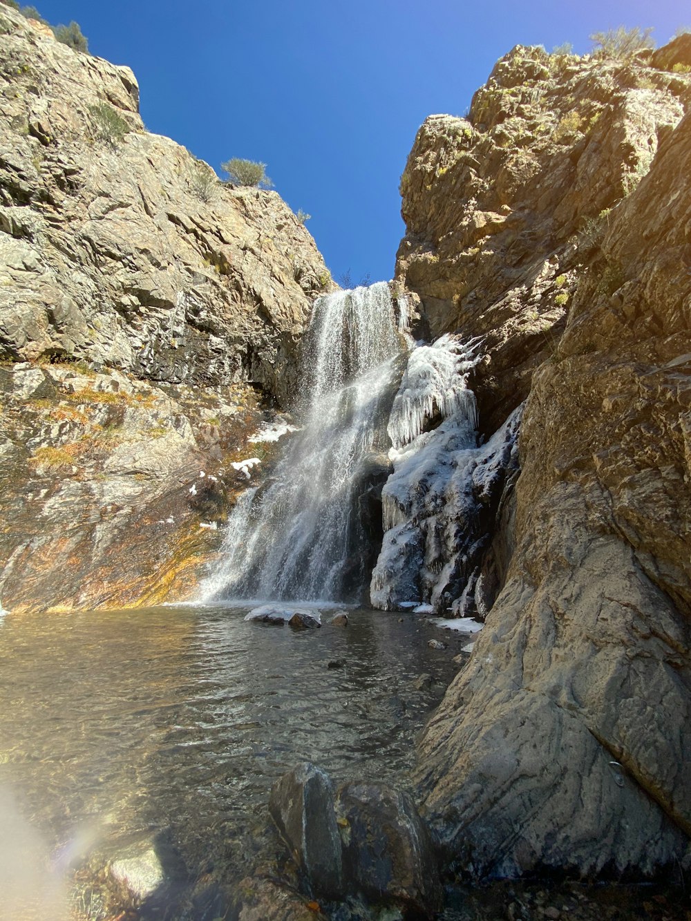 waterfalls surrounded by rock formation