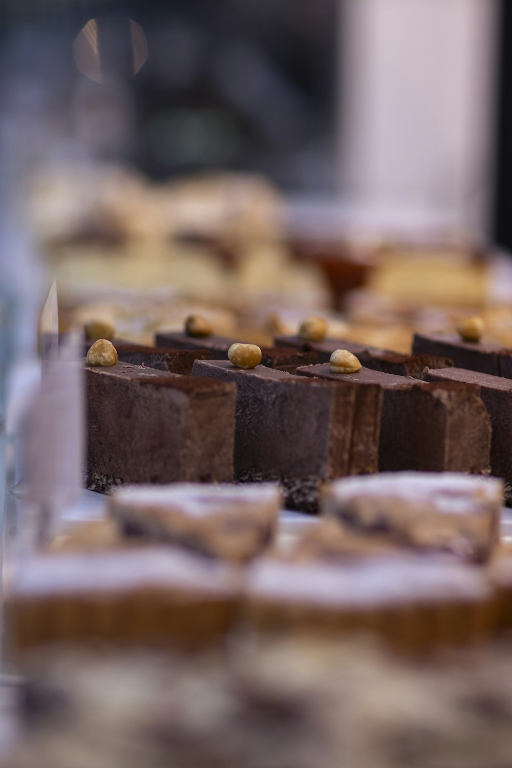 a table topped with lots of brownies covered in frosting