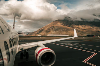 white and red airliner on runway