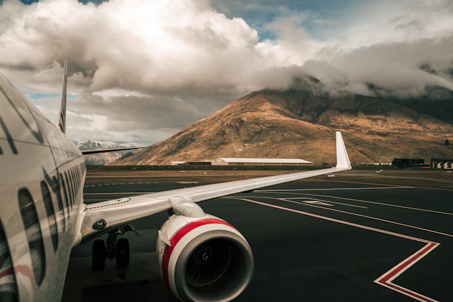 white and red airliner on runway