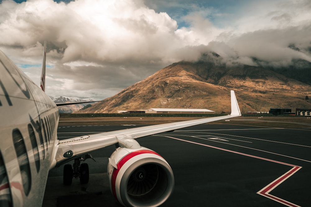 white and red airliner on runway