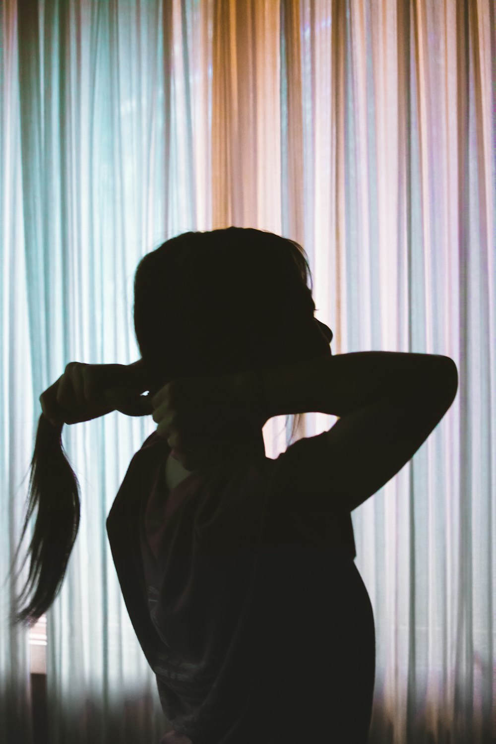 silhouette of person near window