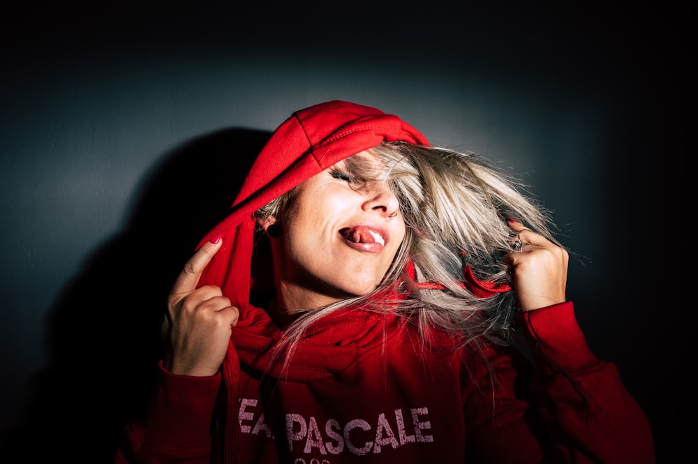 woman wearing red and white pullover hoodie