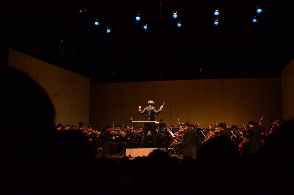 orchestra playing in dim-lit room