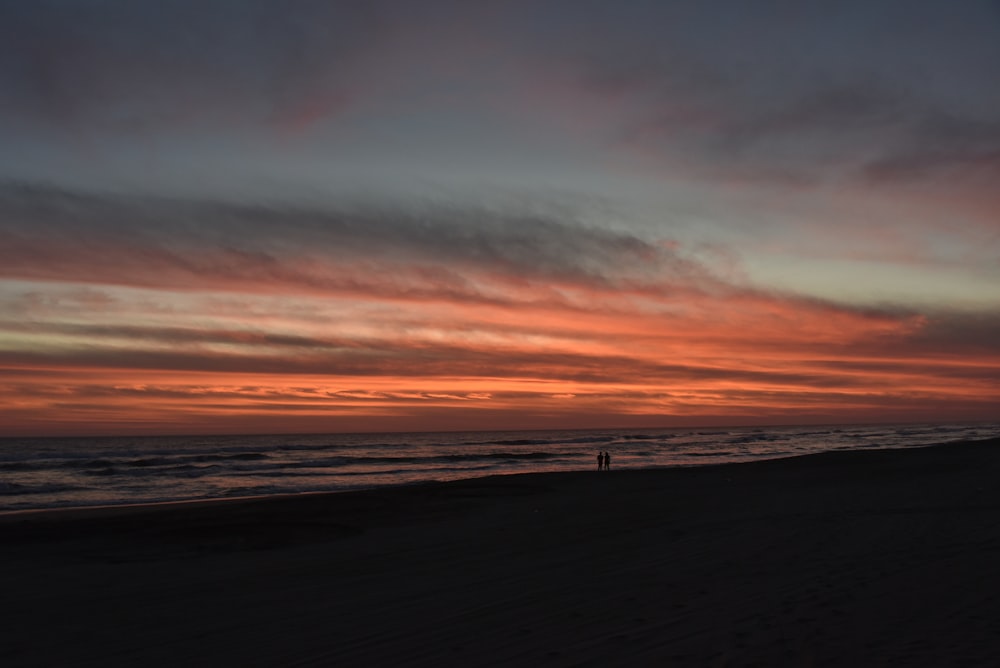 silhouette of person on seashore