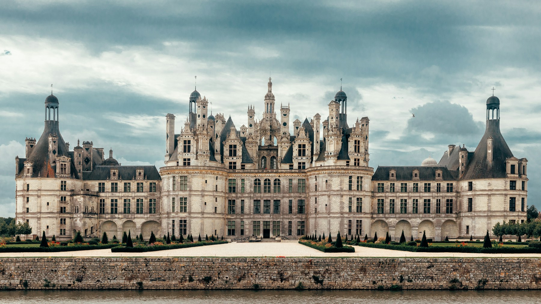 The long gallery of a historic château, light falling across stone