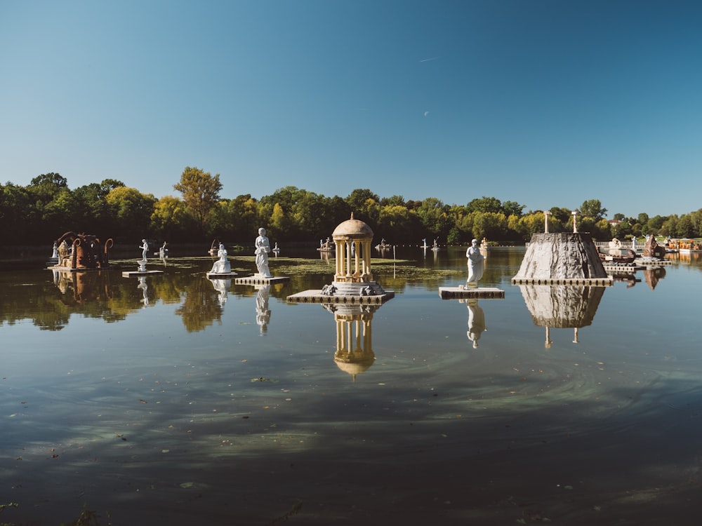 body of water near green trees at daytime