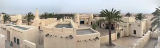 A panoramic view of Rajasthan’s golden desert landscape with a traditional haveli and vibrant Rajasthani folk dancers in colorful attire.