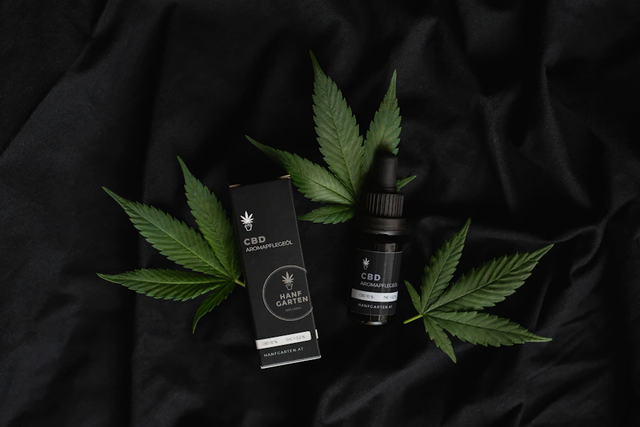 CBD sleep tincture bottle and box with hemp leaves on dark fabric