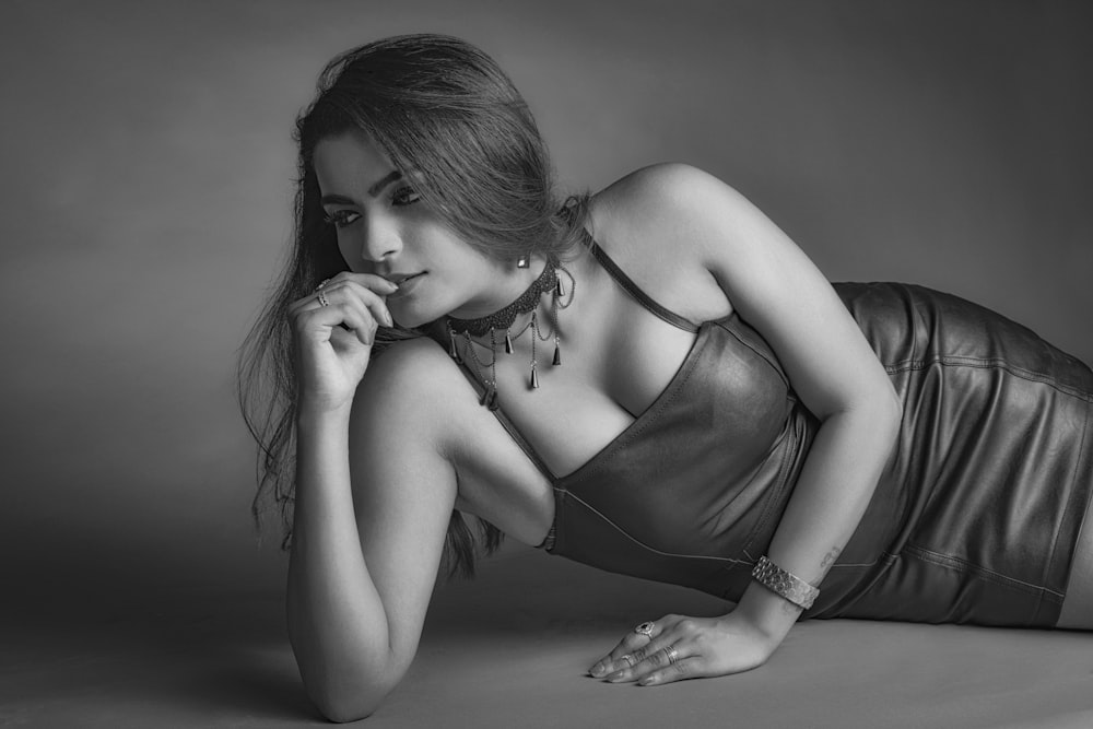 grayscale photography of woman wearing spaghetti strap leather mini dress