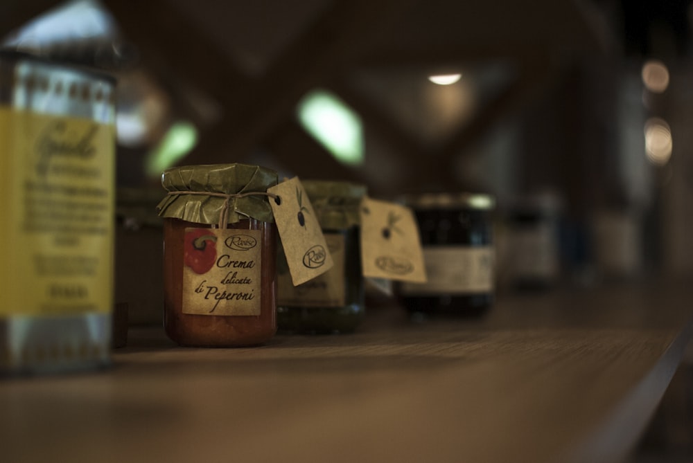 selective focus photography of variety flavored jars of spread