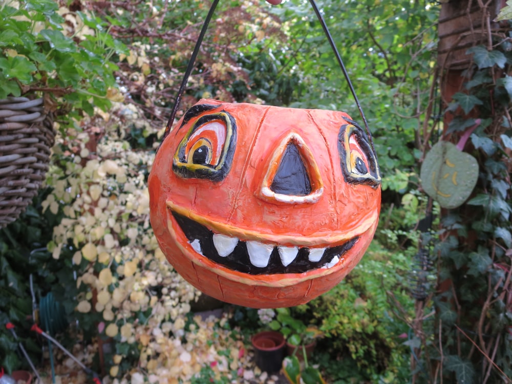 hanging jack-o'-lantern near flowers