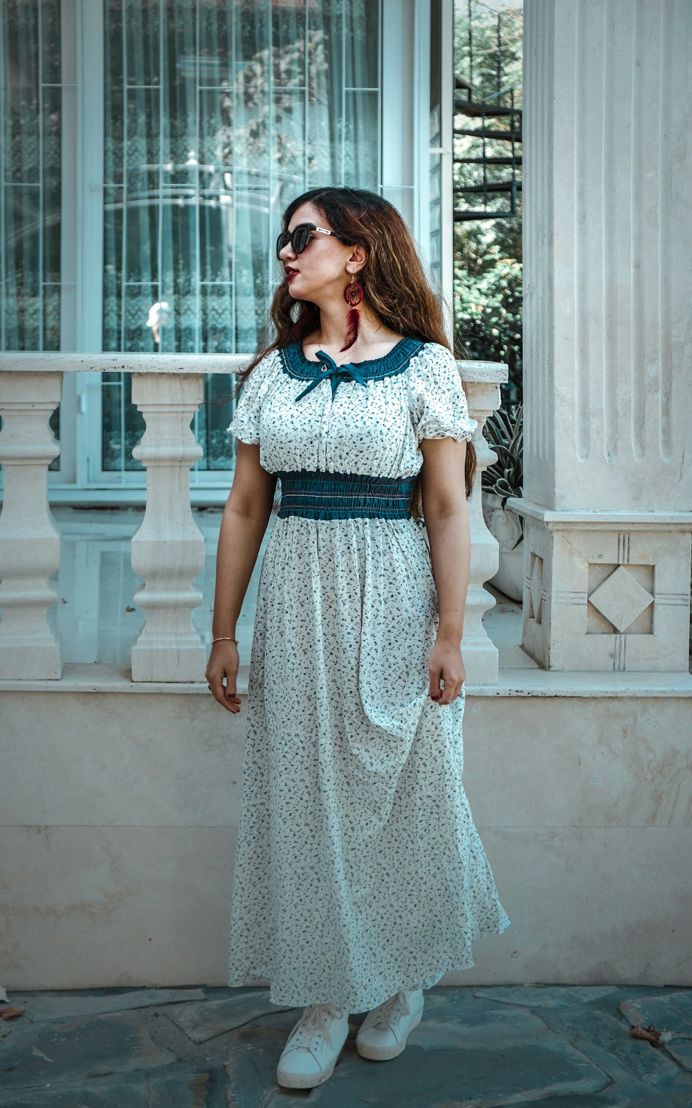 woman standing beside house