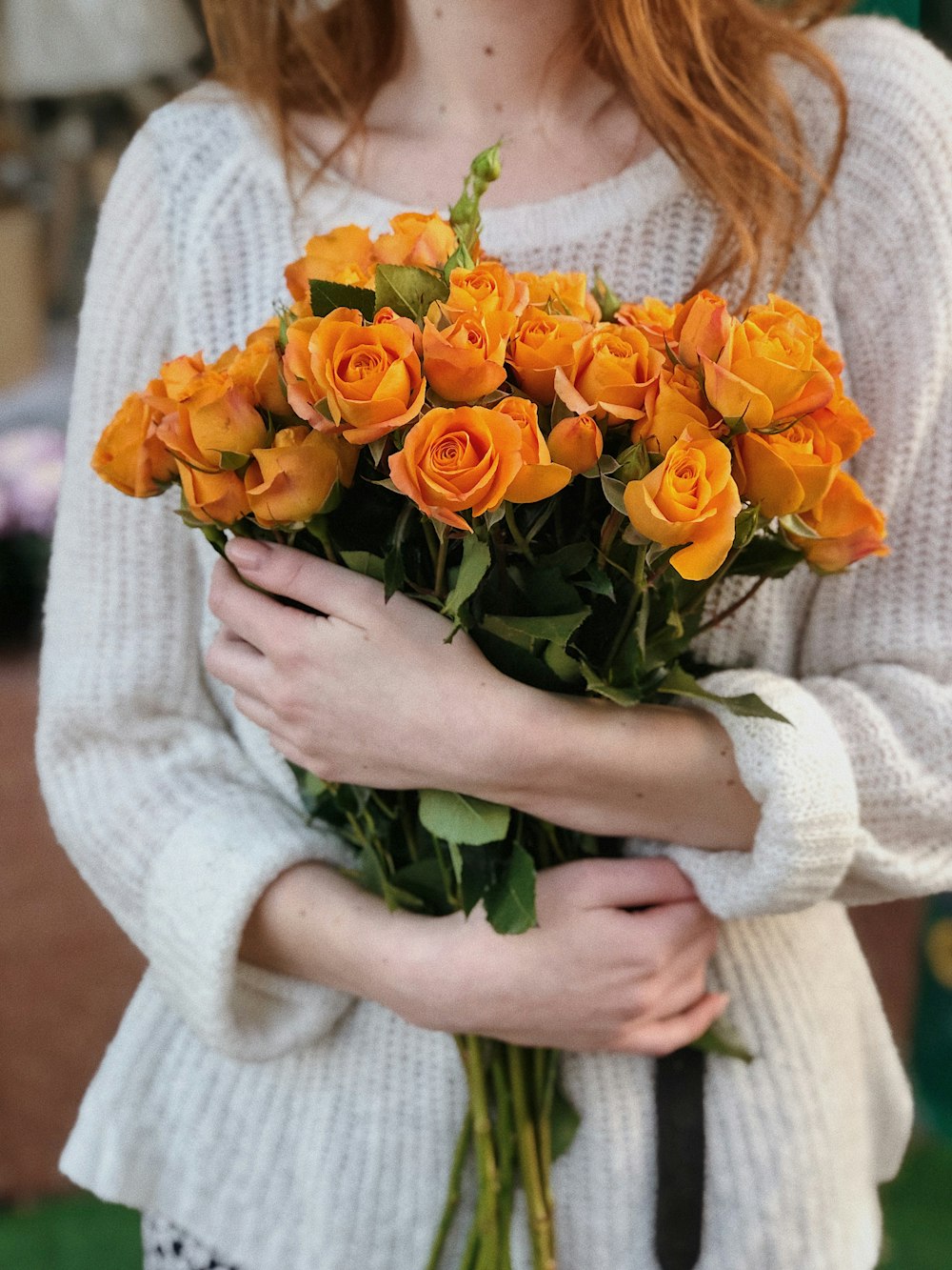 woman carrying yellow rose flowers