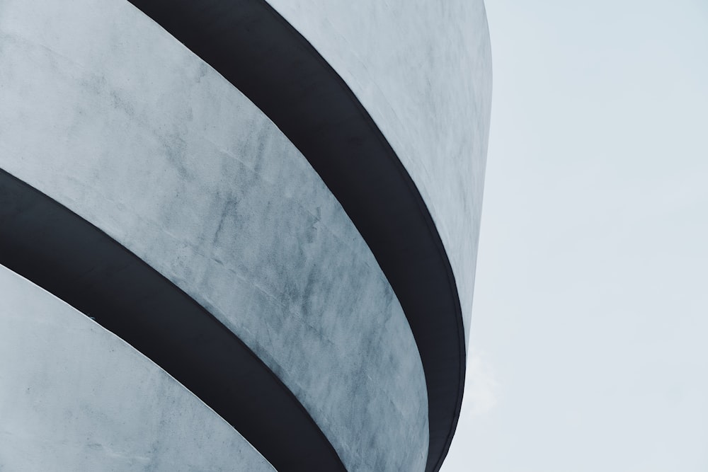 a tall white building with black lines on it's side