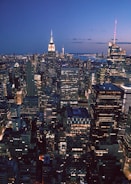 City skyline at dusk with illuminated office buildings
