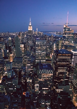 City skyline at dusk with illuminated office buildings