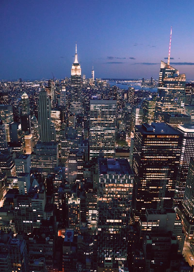 A sleek, modern office skyline at dusk with golden lights reflecting African economic growth.