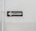 A weathered traffic sign with black text 'TRANSITO' and a left-pointing arrow is mounted against a plain, worn white wall. The sign is rectangular with a black border and white background.