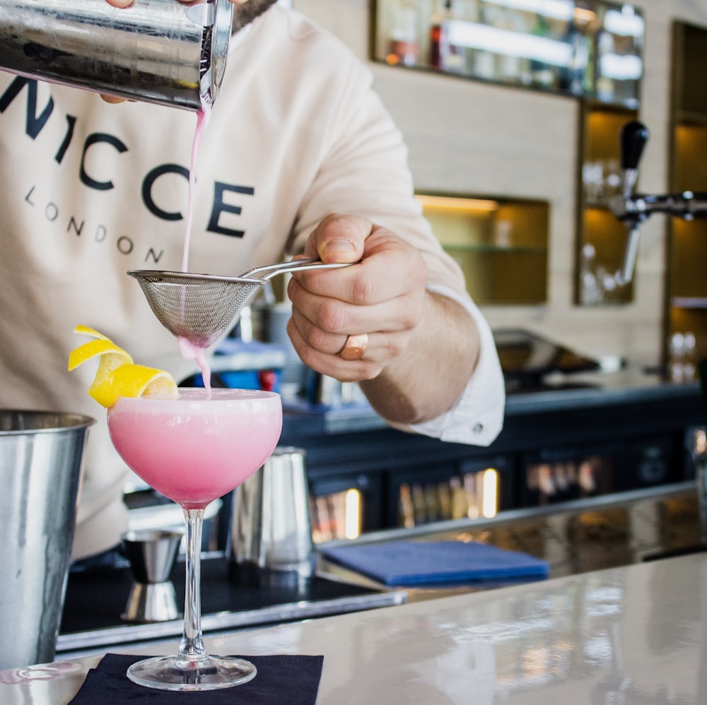 man pouring juice to the glass