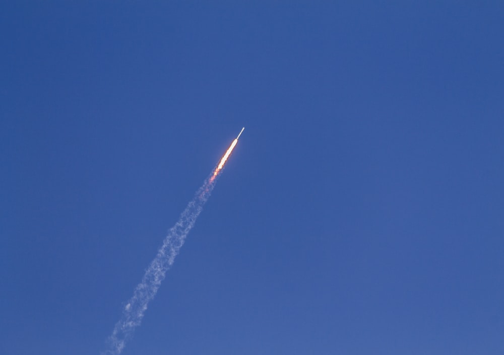 flying rocket during daytime