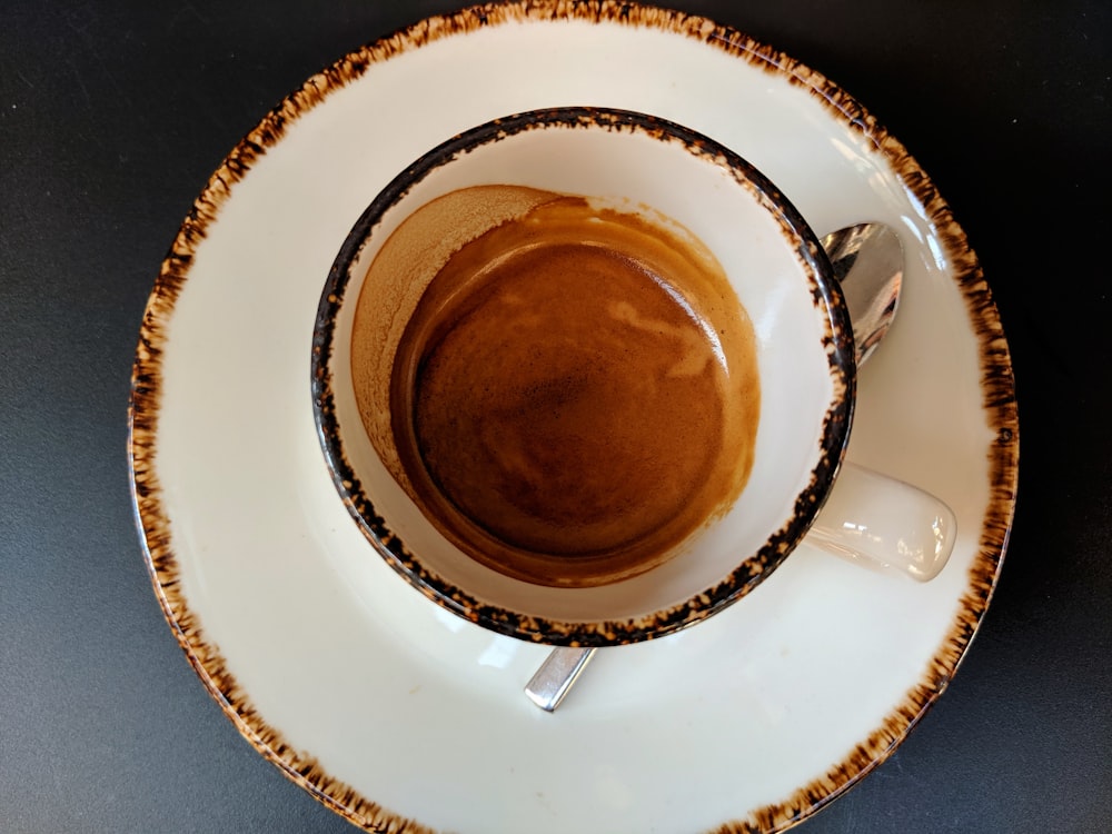 empty white and brown ceramic cup and saucer