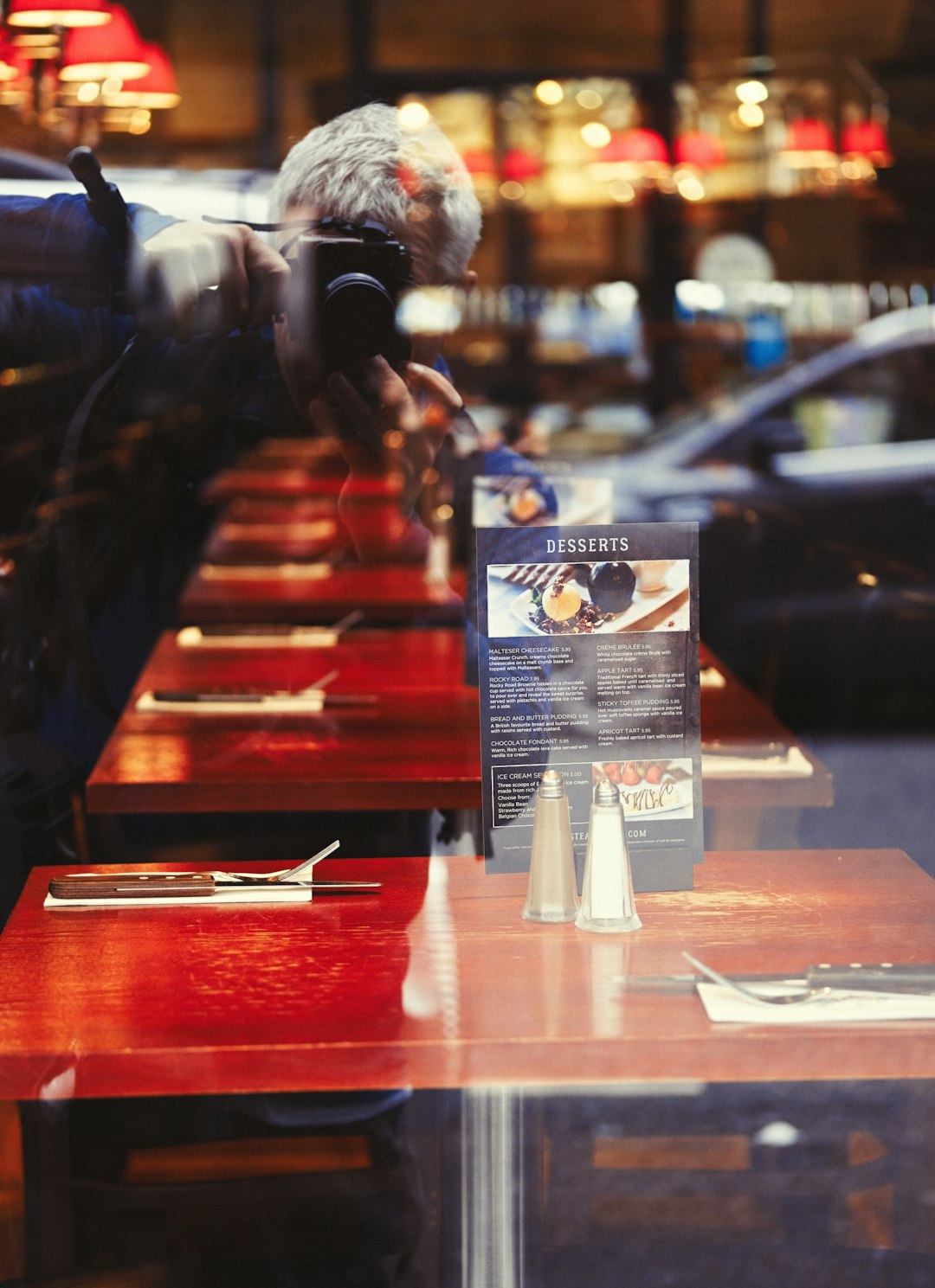 person taking photo of dining table inside restaurant