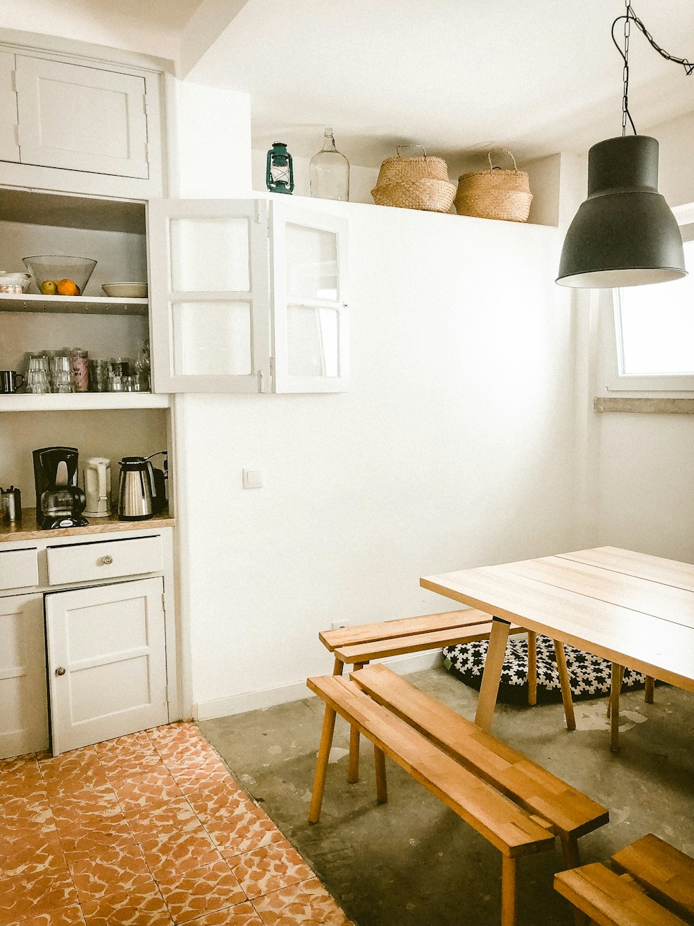 pendant lamp above dining set near cabinet