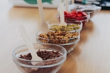 An assortment of colorful fruit toppings for ice cream.
