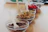 A close-up of various toppings and sauces displayed neatly in small bowls.