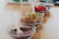 A close-up of various toppings and sauces displayed neatly in small bowls.