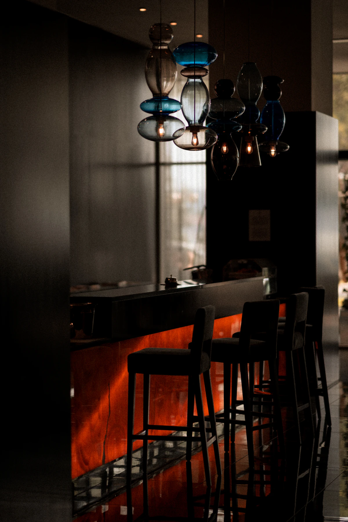 A glass-topped table in a warmly lit wood-panelled room